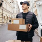 Movers NJ team loading boxes into a truck Jersey City moving company handling home relocation Professional movers NJ carrying furniture safely