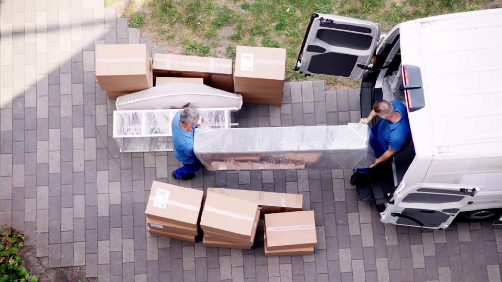 Movers NJ packing boxes for a home relocation Jersey City moving company loading furniture into a moving truck Professional NJ movers carrying household items carefully