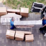 Movers NJ packing boxes for a home relocation Jersey City moving company loading furniture into a moving truck Professional NJ movers carrying household items carefully