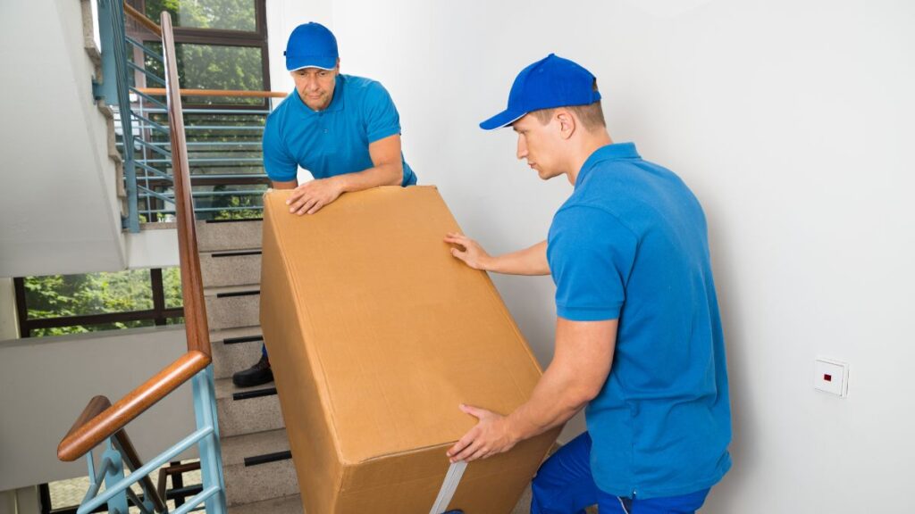 Team from moving company in Newark NJ packing household items Top Jersey City moving company loading furniture into truck Movers wrapping fragile belongings in Newark NJ