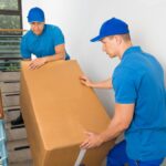Team from moving company in Newark NJ packing household items Top Jersey City moving company loading furniture into truck Movers wrapping fragile belongings in Newark NJ