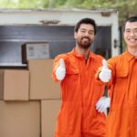 Top Jersey City moving company team from best moving companies in NJ transporting boxes”